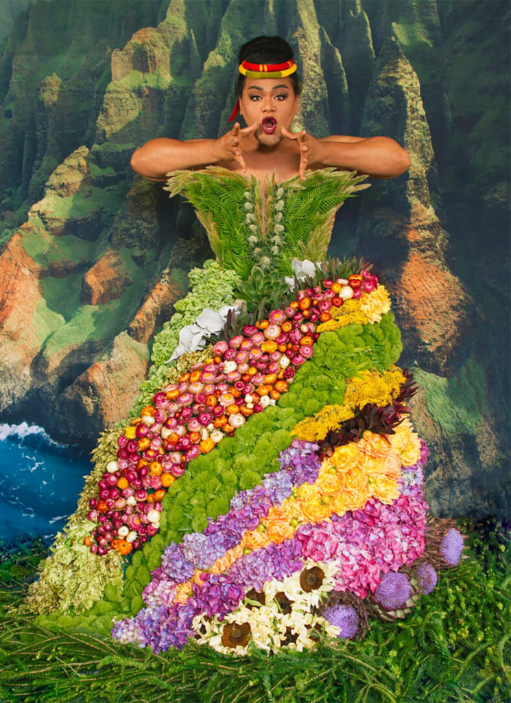 Person dressed up in a costume composed of flowers and plants