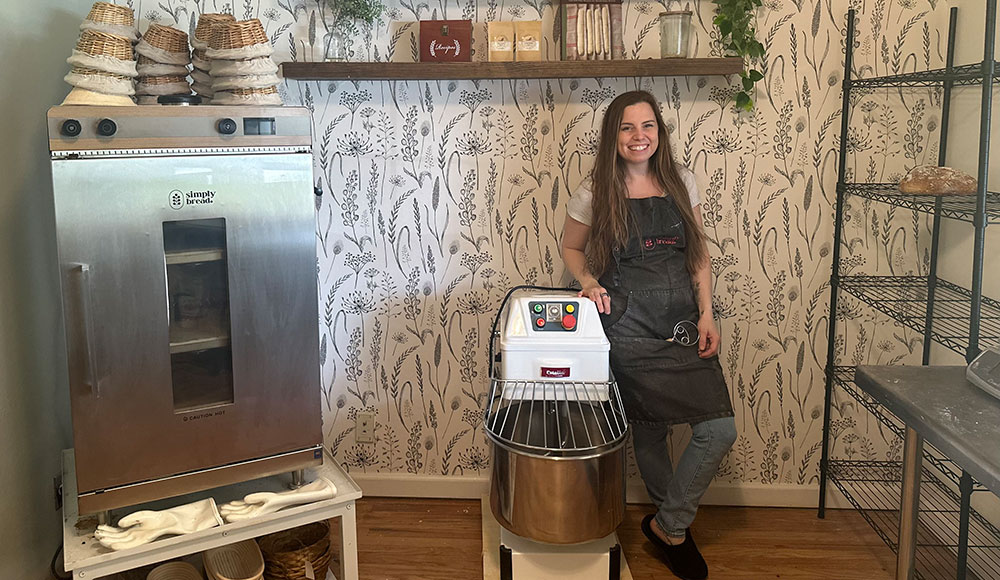 Woman in a kitchen with equipment for bread mating