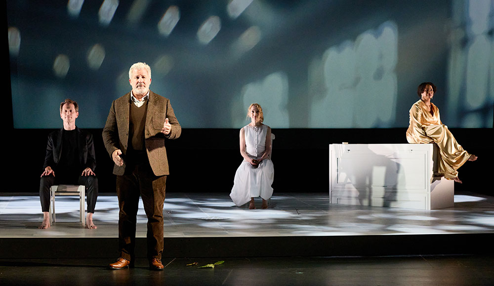 Four people doing a performance on a stage