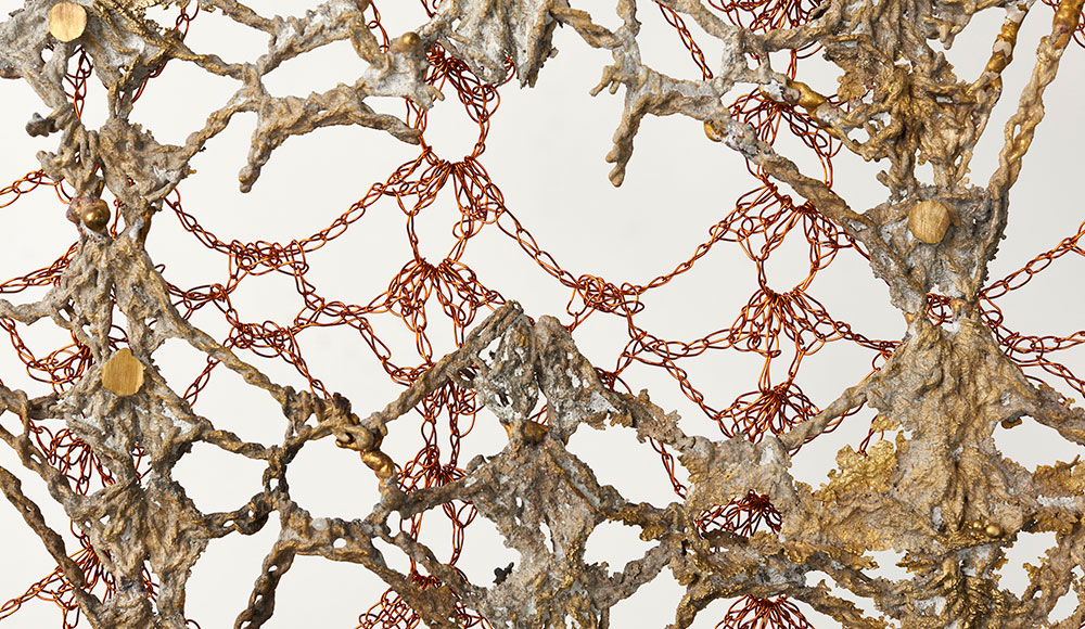 Detail of sculpture made of cast bronze and crocheted copper wire