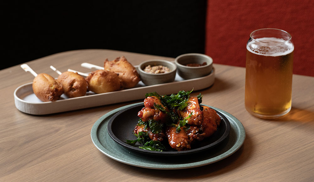 two plates of food and a beer