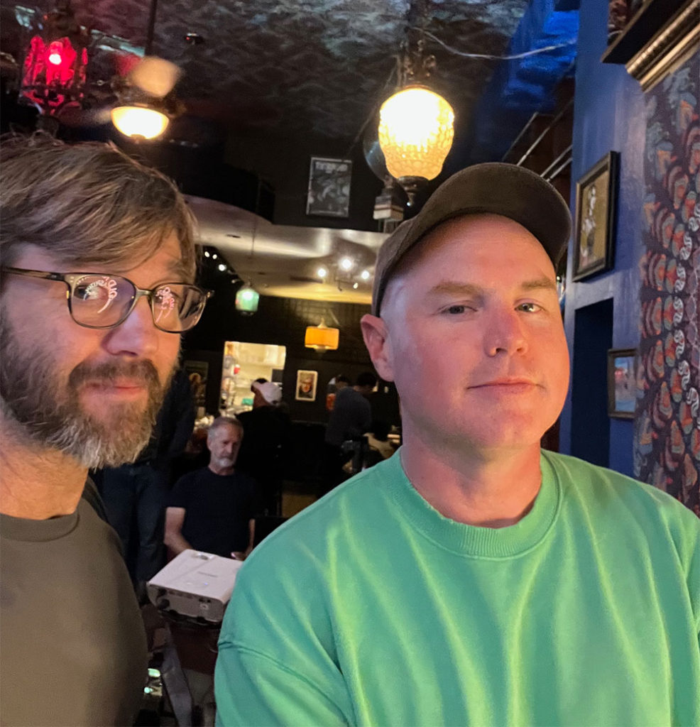 Photo of two men inside a bar