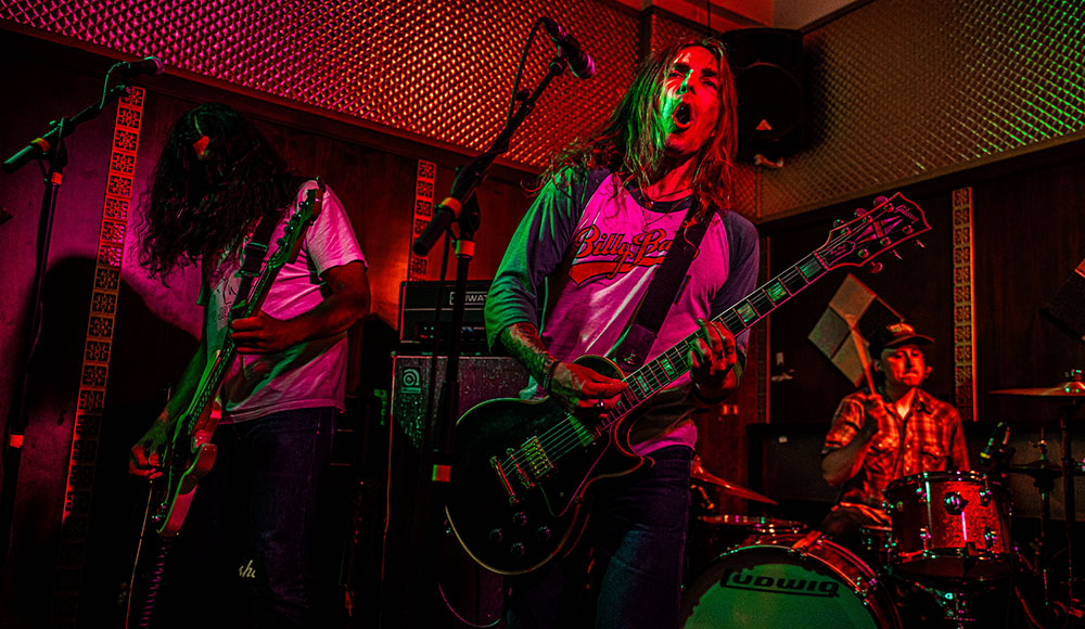 Musicians playing live under colored lights