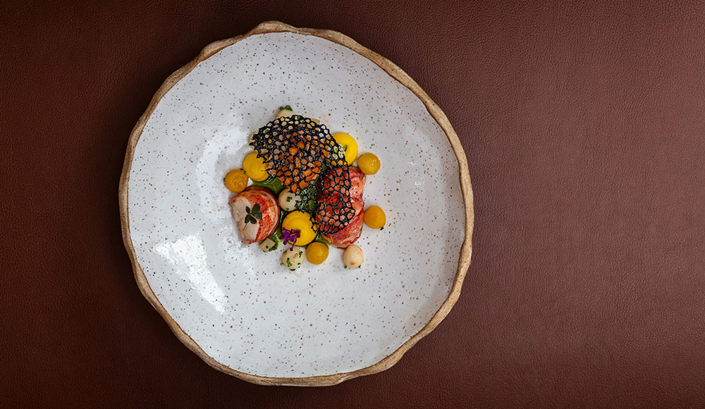 Food in the middle of a very large plate, photographed from above